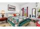 The bedroom features a cozy atmosphere with a decorative quilt and a view to the outside at 25324 Alicante Dr, Punta Gorda, FL 33955