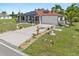 Spacious front yard with decorative landscaping and concrete driveway at 25324 Alicante Dr, Punta Gorda, FL 33955