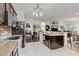 Modern kitchen featuring white marble floors, granite counters, stainless appliances and an open layout into the living room at 25324 Alicante Dr, Punta Gorda, FL 33955
