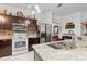 An open kitchen features stainless steel appliances, custom cabinets, and marble countertops at 25324 Alicante Dr, Punta Gorda, FL 33955