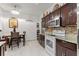 Well-equipped kitchen featuring stainless steel appliances, tile backsplash, a cozy dining area, and generous countertop space at 25324 Alicante Dr, Punta Gorda, FL 33955