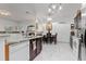 Bright kitchen with white marble floors, modern appliances, a dining area, and seamlessly connected to the living spaces at 25324 Alicante Dr, Punta Gorda, FL 33955