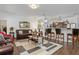 Inviting living room with hardwood flooring, stylish decor, and an open connection to the kitchen area at 25324 Alicante Dr, Punta Gorda, FL 33955