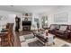 Open-concept living area with hardwood flooring, comfortable seating, and a seamless flow to the outdoors at 25324 Alicante Dr, Punta Gorda, FL 33955