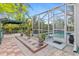 Enclosed patio featuring a pool with an outdoor grilling and dining area at 25324 Alicante Dr, Punta Gorda, FL 33955