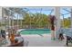 Inviting screened-in pool area with comfortable patio seating and lush landscaping for relaxing outdoor living at 25324 Alicante Dr, Punta Gorda, FL 33955