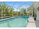 Beautiful screened-in pool with serene water, surrounded by lush landscaping, for ultimate privacy at 25324 Alicante Dr, Punta Gorda, FL 33955