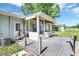 Exterior view of back porch featuring wooden deck and screened-in area at 2622 11Th W Ave, Bradenton, FL 34205