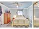 Comfortable bedroom with a ceiling fan, tile floors, a wooden dresser, and a mirror creating a cozy space at 2622 11Th W Ave, Bradenton, FL 34205