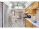Bright kitchen boasts tile flooring, stainless steel refrigerator, and wooden cabinetry at 2622 11Th W Ave, Bradenton, FL 34205