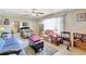 Bright living room featuring tile floors, ceiling fan, and comfortable seating area at 2622 11Th W Ave, Bradenton, FL 34205