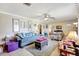 Bright living room featuring tile floors, ceiling fan, and comfortable seating at 2622 11Th W Ave, Bradenton, FL 34205