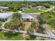 An aerial shot of the home, lush landscaping, fenced yard, and neighborhood at 2794 Escambia Cir, North Port, FL 34288