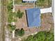 An aerial view showing metal roof, fenced yard and perimeter landscaping at 2794 Escambia Cir, North Port, FL 34288