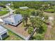 Aerial view of the home and grounds including perimeter fence, lush landscaping at 2794 Escambia Cir, North Port, FL 34288