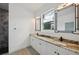 Bathroom featuring double vanities with stone countertop, undermount sinks and designer mirrors at 2794 Escambia Cir, North Port, FL 34288