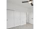 Bedroom showcasing closet, tile floors, open doorway, and contemporary ceiling fan at 2794 Escambia Cir, North Port, FL 34288