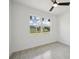 Well-lit bedroom with a neutral color scheme, ceiling fan, and a large window at 2794 Escambia Cir, North Port, FL 34288