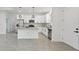 Bright, open kitchen with white cabinetry, island with countertop, and stainless steel appliances at 2794 Escambia Cir, North Port, FL 34288