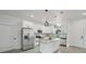 Bright, open kitchen with white cabinetry, island with countertop, and stainless steel appliances at 2794 Escambia Cir, North Port, FL 34288