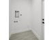 A laundry room featuring connections and stylish gray flooring, ready for appliances at 2794 Escambia Cir, North Port, FL 34288