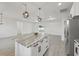 Open-concept living and kitchen area with tile floors and bright, neutral decor at 2794 Escambia Cir, North Port, FL 34288
