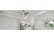 Modern living space featuring an open concept, ceiling fan, recessed lights, and stainless appliances at 2794 Escambia Cir, North Port, FL 34288