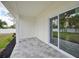 Covered patio with tile flooring, perfect for outdoor relaxation and entertaining, adjacent to a lush backyard at 2794 Escambia Cir, North Port, FL 34288
