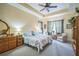 Tranquil Primary bedroom featuring a tray ceiling, soft lighting, and neutral decor at 3041 Stonegate Falls Dr, Land O Lakes, FL 34638