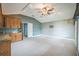Large bonus room featuring carpet, storage cabinets, and a ceiling fan at 3041 Stonegate Falls Dr, Land O Lakes, FL 34638