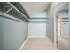 Walk-in closet with carpet, built-in shelving, and a clothing rack at 3041 Stonegate Falls Dr, Land O Lakes, FL 34638
