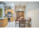 Cozy dining area next to the kitchen, featuring modern lighting and comfortable seating at 3041 Stonegate Falls Dr, Land O Lakes, FL 34638