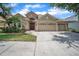 Charming single-story home featuring a three-car garage and lush landscaping in a desirable location at 3041 Stonegate Falls Dr, Land O Lakes, FL 34638
