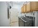 Laundry room with washer, dryer, cabinets, and storage space at 3041 Stonegate Falls Dr, Land O Lakes, FL 34638