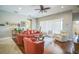 Spacious living room with hardwood floors, bright windows, and a comfortable seating area at 3041 Stonegate Falls Dr, Land O Lakes, FL 34638