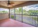 Relaxing screened porch with a fan and scenic water view at 3041 Stonegate Falls Dr, Land O Lakes, FL 34638