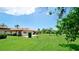 Expansive backyard view with lush landscaping and well-maintained lawns, surrounded by charming residences at 3305 Notre Dame Pl # 3305, Bradenton, FL 34207