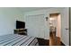 Bedroom with large closet, television, and view into a sunlit adjacent room at 3305 Notre Dame Pl # 3305, Bradenton, FL 34207
