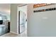 Hallway view leading to a modern stainless steel refrigerator in the adjacent kitchen at 3305 Notre Dame Pl # 3305, Bradenton, FL 34207