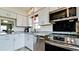 Updated kitchen featuring stainless steel appliances, white cabinetry, and modern fixtures at 3305 Notre Dame Pl # 3305, Bradenton, FL 34207