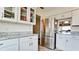 Well-lit kitchen with white cabinetry, granite countertops, and stainless steel refrigerator at 3305 Notre Dame Pl # 3305, Bradenton, FL 34207