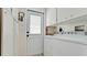 Functional laundry room with washer, dryer, overhead cabinets, and convenient access to the outside at 3305 Notre Dame Pl # 3305, Bradenton, FL 34207