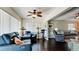 Spacious living room with comfortable seating, a ceiling fan, dark wood floors, and view to open dining area at 3305 Notre Dame Pl # 3305, Bradenton, FL 34207