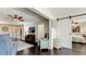 Bright living room featuring dark wood floors, comfortable seating, and a sliding barn door to the main bedroom at 3305 Notre Dame Pl # 3305, Bradenton, FL 34207