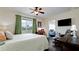 Cozy main bedroom with dark wood floors, green curtains, and a view to the living room at 3305 Notre Dame Pl # 3305, Bradenton, FL 34207