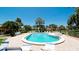 Beautiful community pool surrounded by tropical foliage, lounge chairs and meticulously kept patio at 3305 Notre Dame Pl # 3305, Bradenton, FL 34207