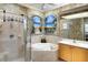 Spa-like bathroom featuring a soaking tub, walk-in shower, and themed wall art at 362 Fairway Isles Ln, Bradenton, FL 34212