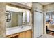Bathroom features a large mirror, wooden vanity, and tiled floors at 362 Fairway Isles Ln, Bradenton, FL 34212