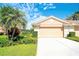 Inviting one-story home features a lush landscaped front yard with a private two-car garage at 362 Fairway Isles Ln, Bradenton, FL 34212