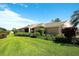 Charming single-story home with verdant lawn, lush landscaping, and a tile roof at 362 Fairway Isles Ln, Bradenton, FL 34212